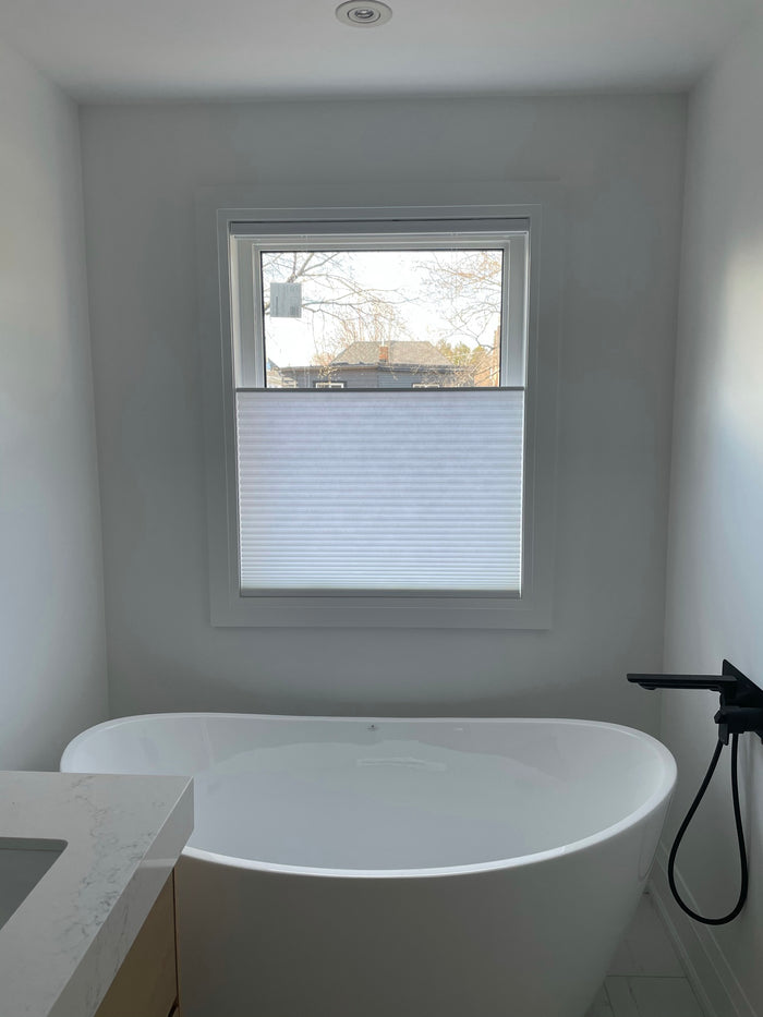 This client wanted privacy with the option to keep daylight in their bright, spa-like bathroom