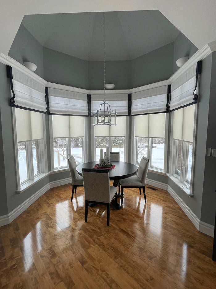 Roman shades in this bow window gave the client a beautiful modern bistro feel